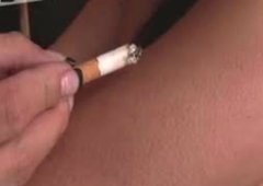 Tied up brunette bitch is smoking cigarette. BDSM porn action
