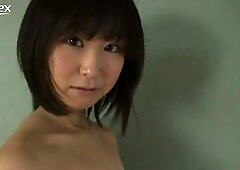 Whorish japán lány yumi ishikaw poses on a camera wearing ripped off top
